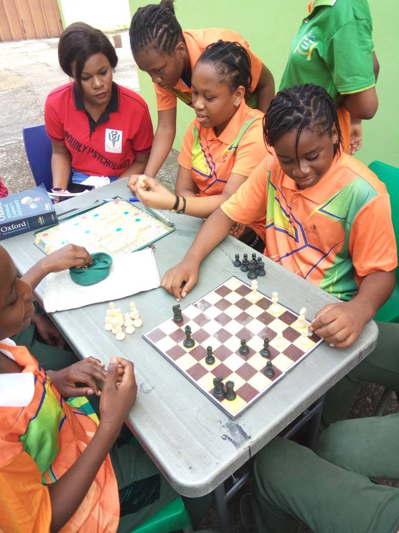 Students and teacher playing chess and Scrabble